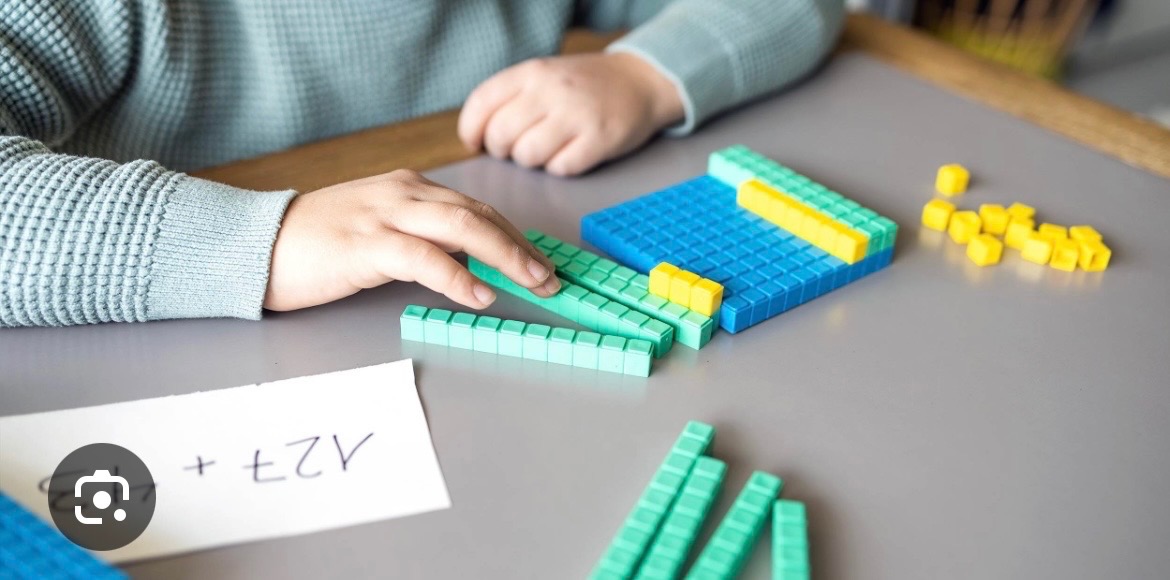 Hands using base-ten blocks for hands-on math learning